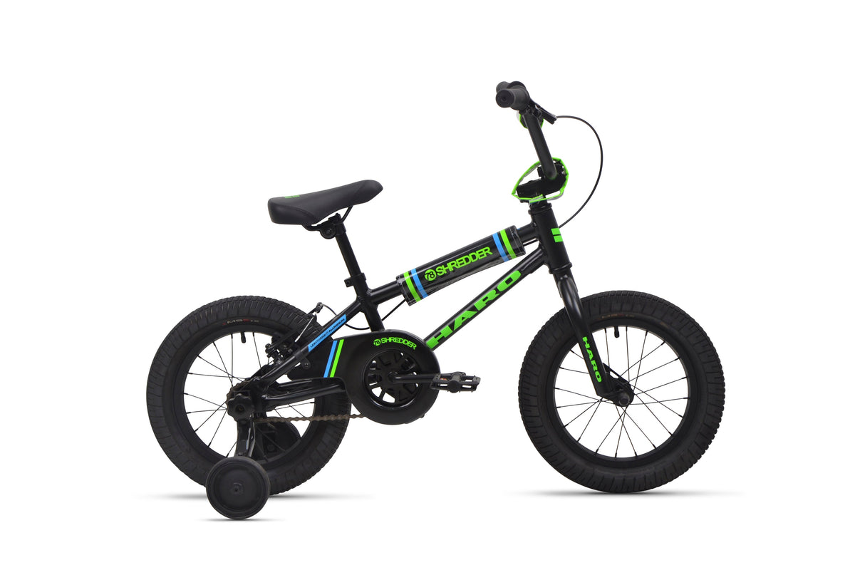 Shredder 14 kids' bike, black/green, lightweight alloy frame with training wheels, side view on white background.
