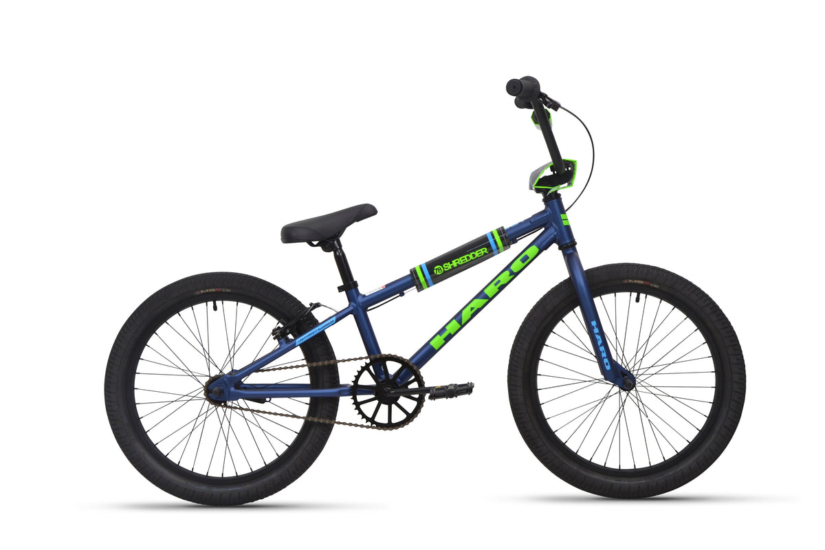 Blue and green Shredder 20 BMX bike with 20" wheels, black tires, alloy frame, upright handlebars; side view on white.
